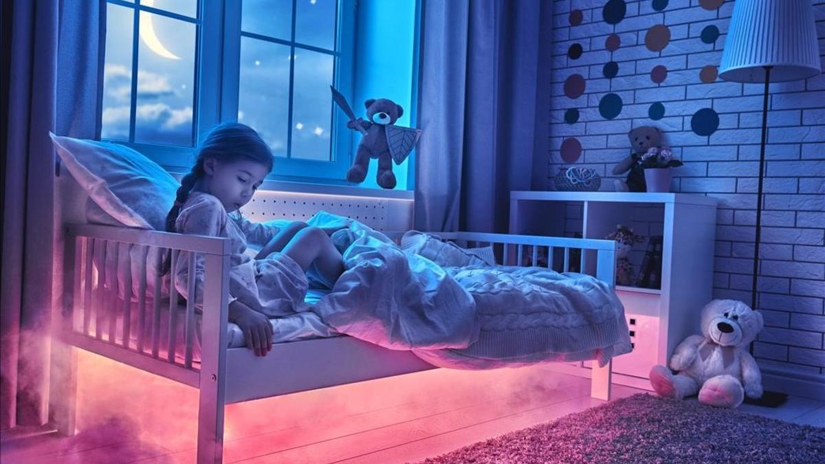 Una niña en su cama con su amigo imaginario