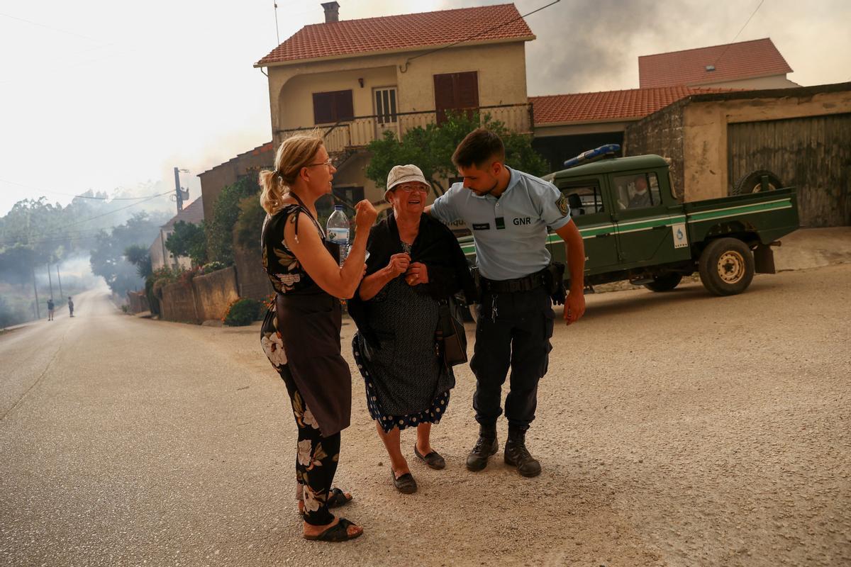 La gente evacua después de un incendio forestal, en Leiria, Portugal, 13 de julio de 2022. REUTERS/Rodrigo Antunes