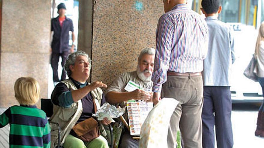 Un hombre compra lotería de Navidad en la calle de Mesa y López, el pasado sábado en la capital grancanaria.  ADOLFO MARRERO