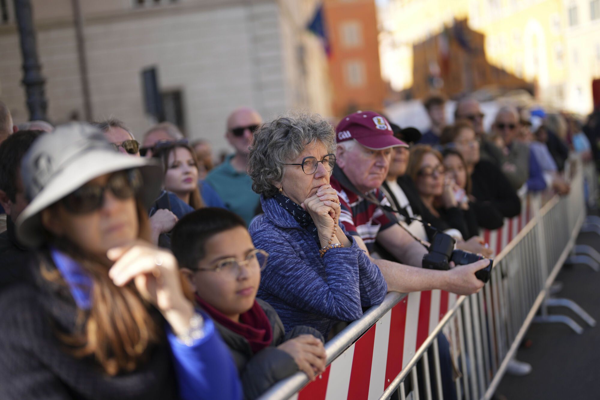People watch the funeral of Pope Francis on a monitor outside St. Mary Major Basilica in Rome Saturday, April 26, 2025. (AP Photo/Francisco Seco). EDITORIAL USE ONLY/ONLY ITALY AND SPAIN