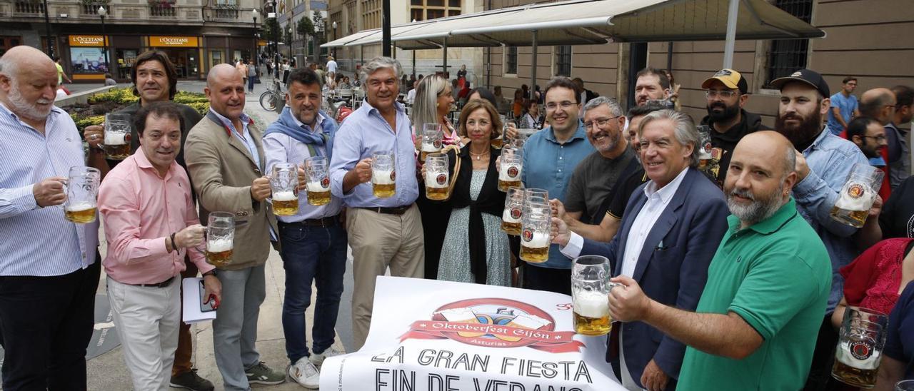 Brindis frente al Café del Parchís, ayer, tras la presentación del Oktoberfest de Gijón. 
Ángel González