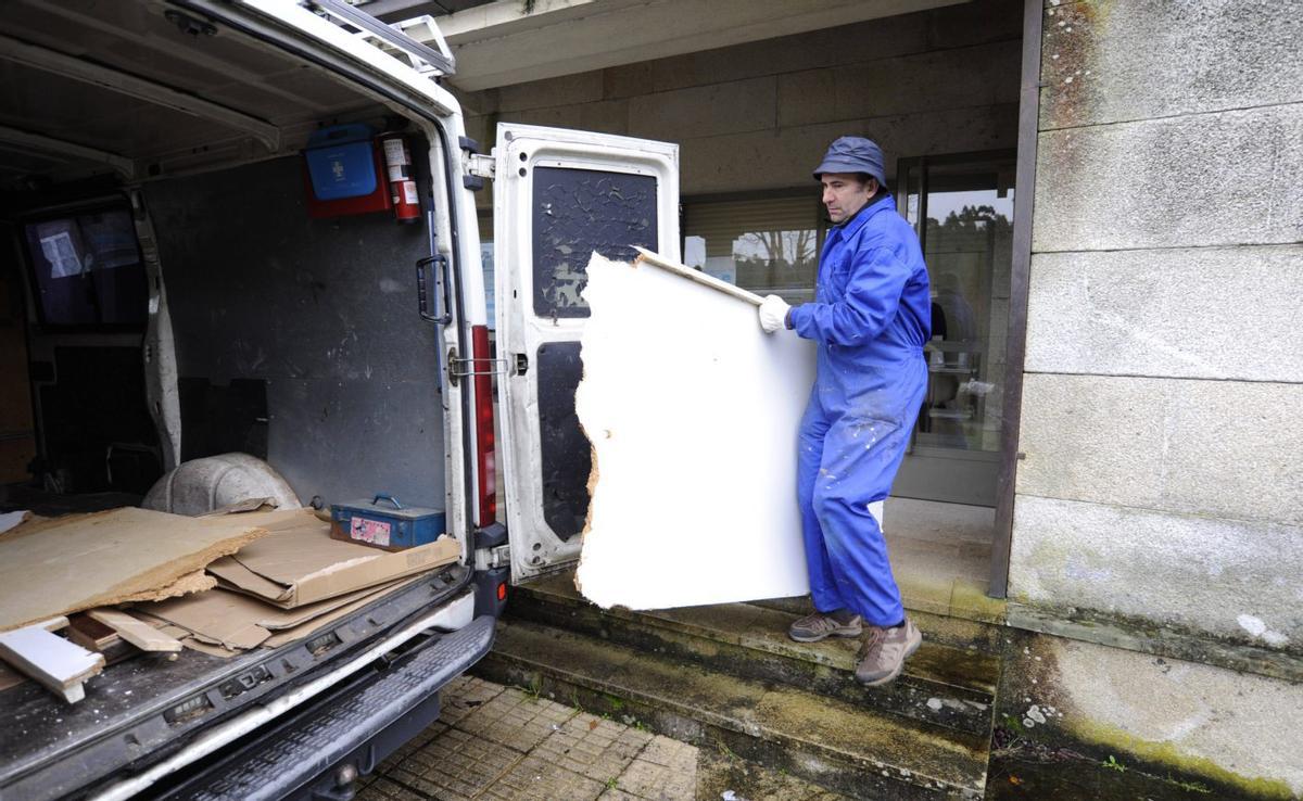Operarios en el centro de salud de Oca, con problemas de goteras este invierno.  |