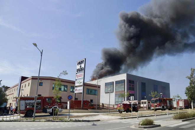 Los Bombers trabajan para evitar que el fuego en una industria textil de Mataró se propague a otras naves de la empresa