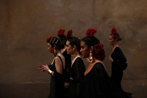 Models wearing flamenca dresses walk before taking part in an event to mark the twentieth anniversary of the International Flamenco Fashion Show SIMOF in Seville