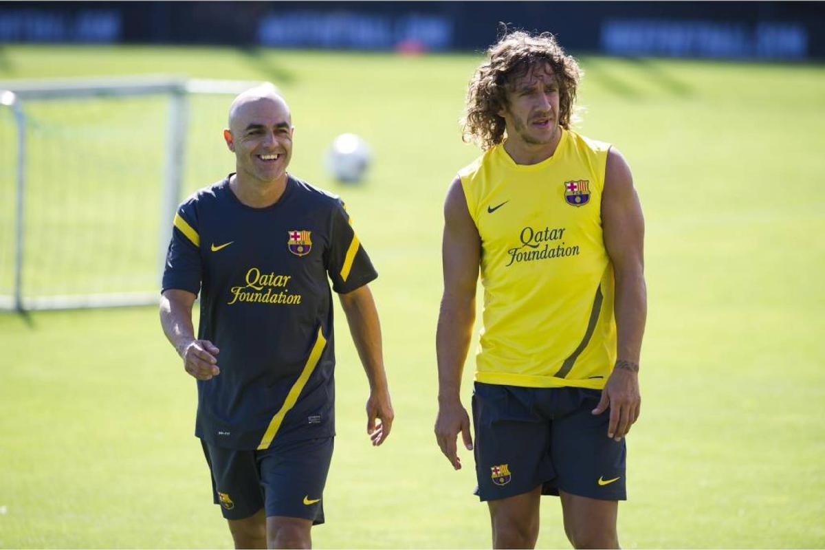 Juanjo Brau, junto a Carles Puyol durante la etapa de ambos en el Barça