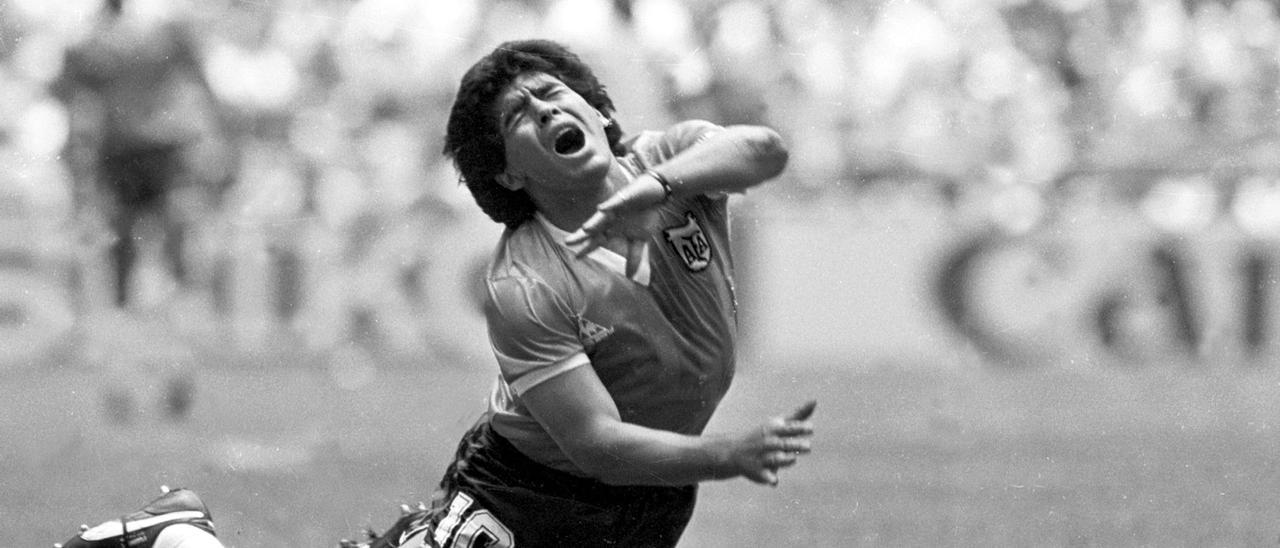 FILE PHOTO: ARGENTINE DIEGO MARADONA FALLS TO THE PITCH IN WORLD CUP MATCH.