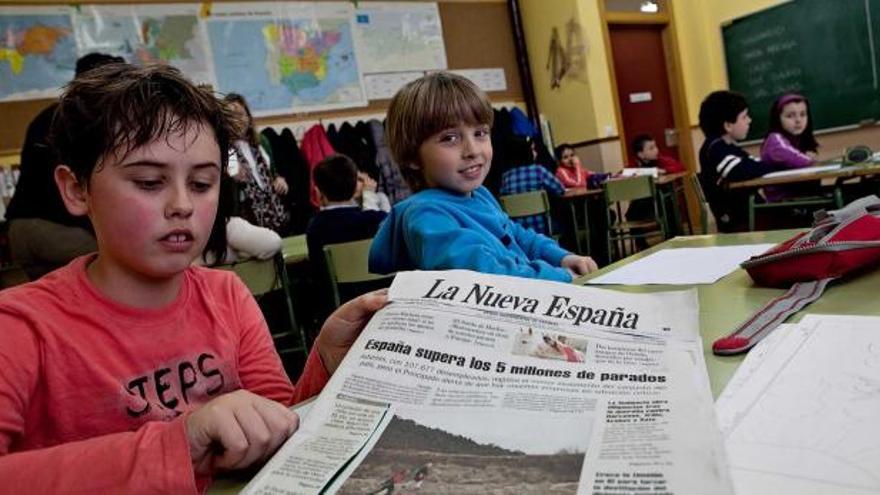 Por la izquierda, Pelayo Bueno y Pelayo Rodríguez, con un ejemplar de LA NUEVA ESPAÑA, ayer, en el colegio público de San Claudio.