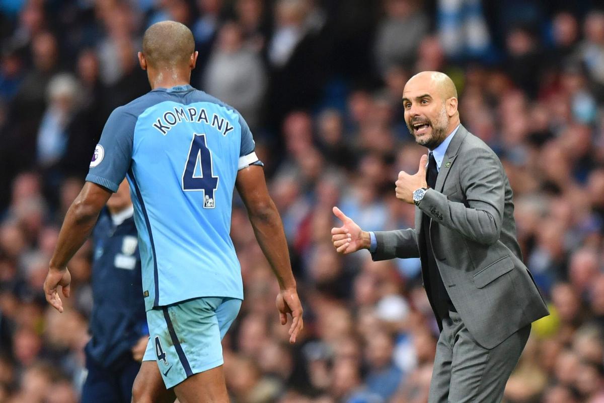 Manchester City's Spanish manager Pep Guardiola (R) gives instructions to Manchester City's Belgian defender Vincent Kompany (L) during the English Premier League football match between Manchester City and West Bromwich Albion at the Etihad Stadium in Manchester, north west England, on May 16, 2017. / AFP PHOTO / Anthony Devlin / RESTRICTED TO EDITORIAL USE. No use with unauthorized audio, video, data, fixture lists, club/league logos or 'live' services. Online in-match use limited to 75 images, no video emulation. No use in betting, games or single club/league/player publications.  /. HORIZONTAL