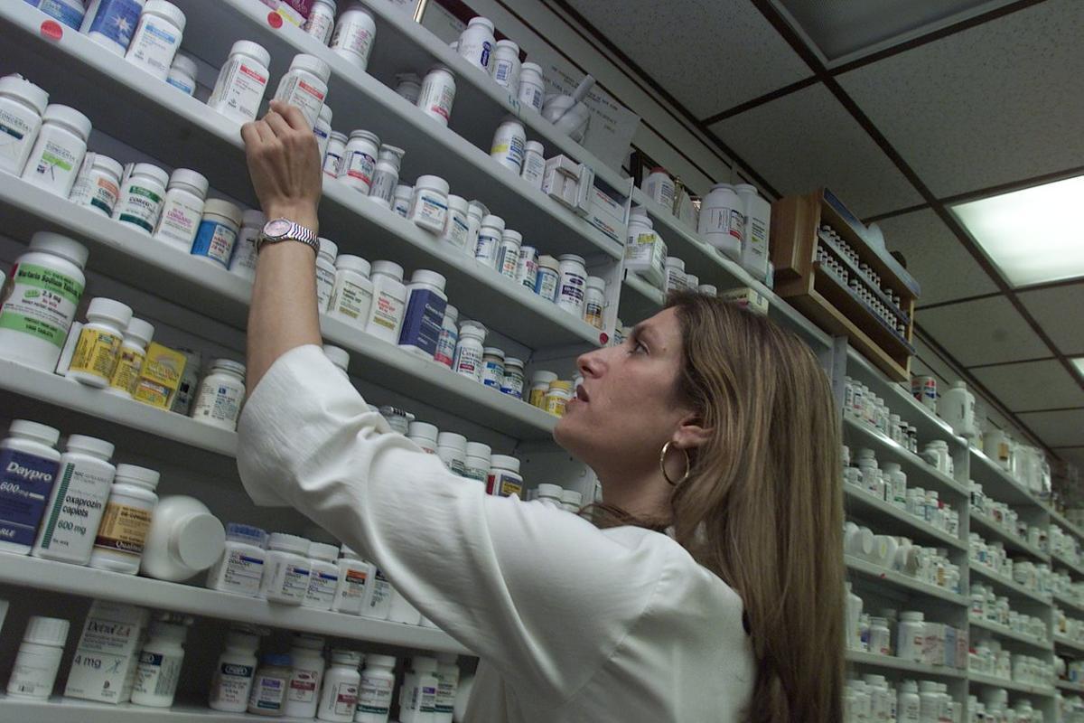 Pharmacist Amy Sidney replaces the antibiotic Cipro on the shelf of her drugstore Saturday, Oct. 13, 2001, in New York. Sidney’s pharmacy was overwhelmed by requests to fill prescriptions for the antibiotic after a confirmed case of Anthrax was reported Friday in New York and forced to limit each prescription to a ten day supply.  (AP Photo/Beth A. Keiser)