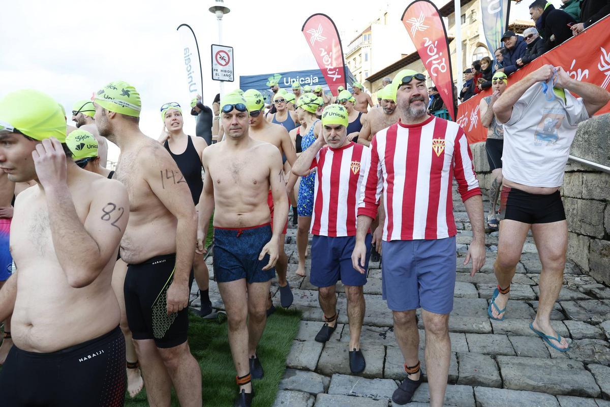 La travesía a nado de Navidad en Gijón congrega un año más a decenas de participantes (en imágenes)