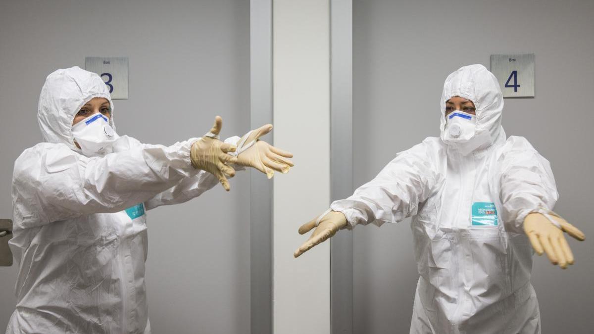 Dos sanitarios se protegen en un hospital de enfermedades infecciosas.