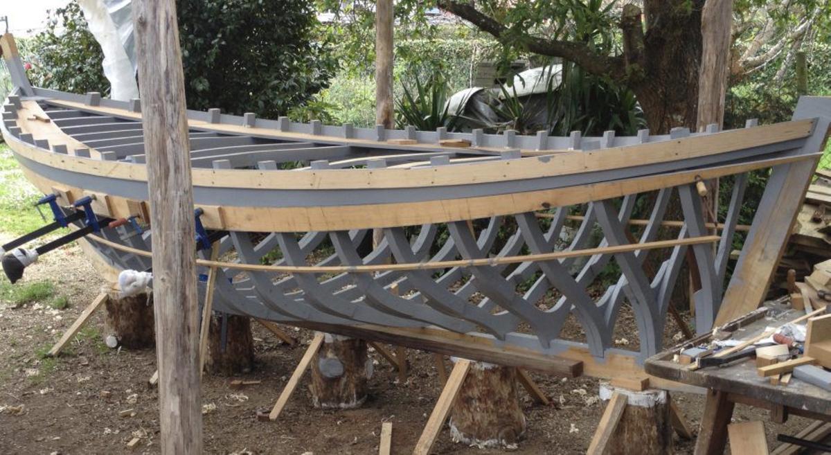 Jorge Carril en su taller de Oleiros y algunas de sus obras, entre ellas, un bote polbeiro (abajo), uno de sus proyectos más queridos.