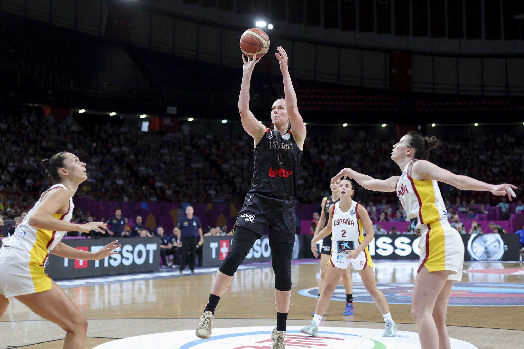 Belgium's Emma Meesseman, centre, tries to score against Spain, during the FIBA Women's EuroBasket 2025 final match between Spain and Belgium at the Peace and Friendship Stadium in Piraeus near Athens, Greece, Sunday, June 29, 2025. (AP Photo/Yorgos Karahalis)