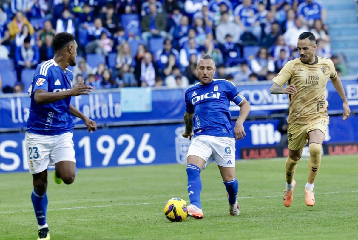 Cazorla dando un pase a Hassan ante Manu Molina.