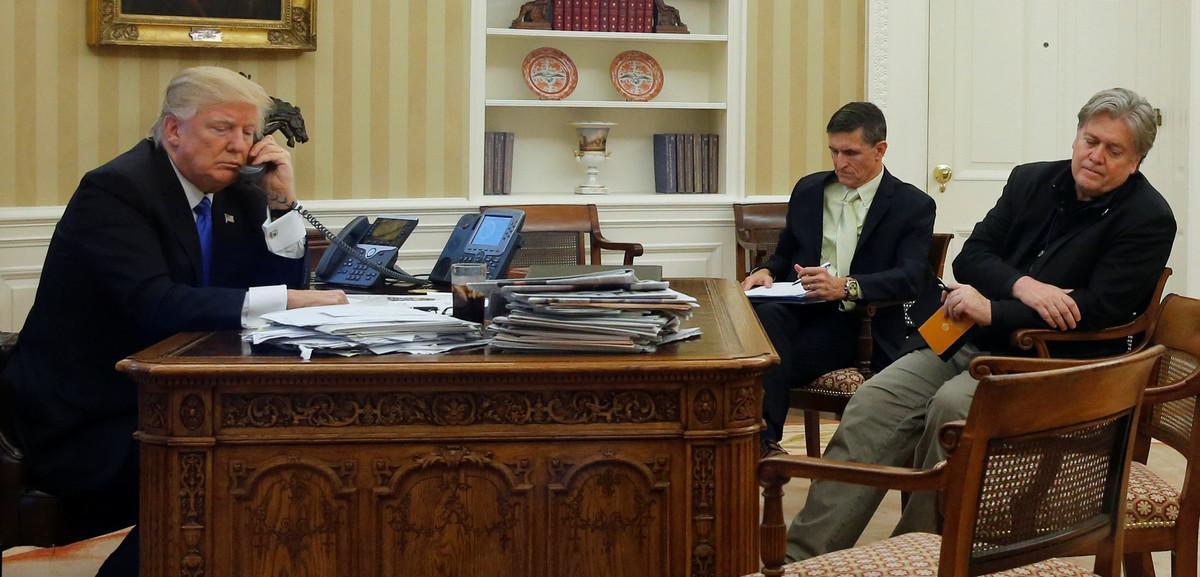 U.S. President Donald Trump (L), seated at his desk with National Security Advisor Michael Flynn (2nd R) and senior advisor Steve Bannon (R), speaks by phone with Australia’s Prime Minister Malcolm Turnbull in the Oval Office at the White House in Washington, U.S. January 28, 2017. REUTERS/Jonathan Ernst