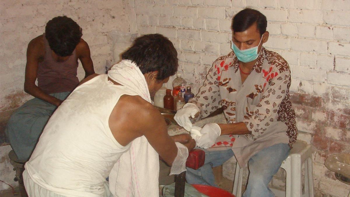 Un grupo de enfermos de lepra recibe tratamiento en un centro de la India