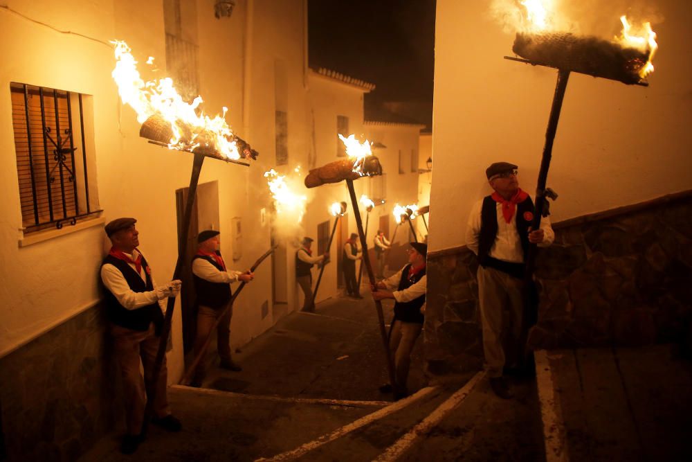 Villagers hold torches during the Divina Pastora ...