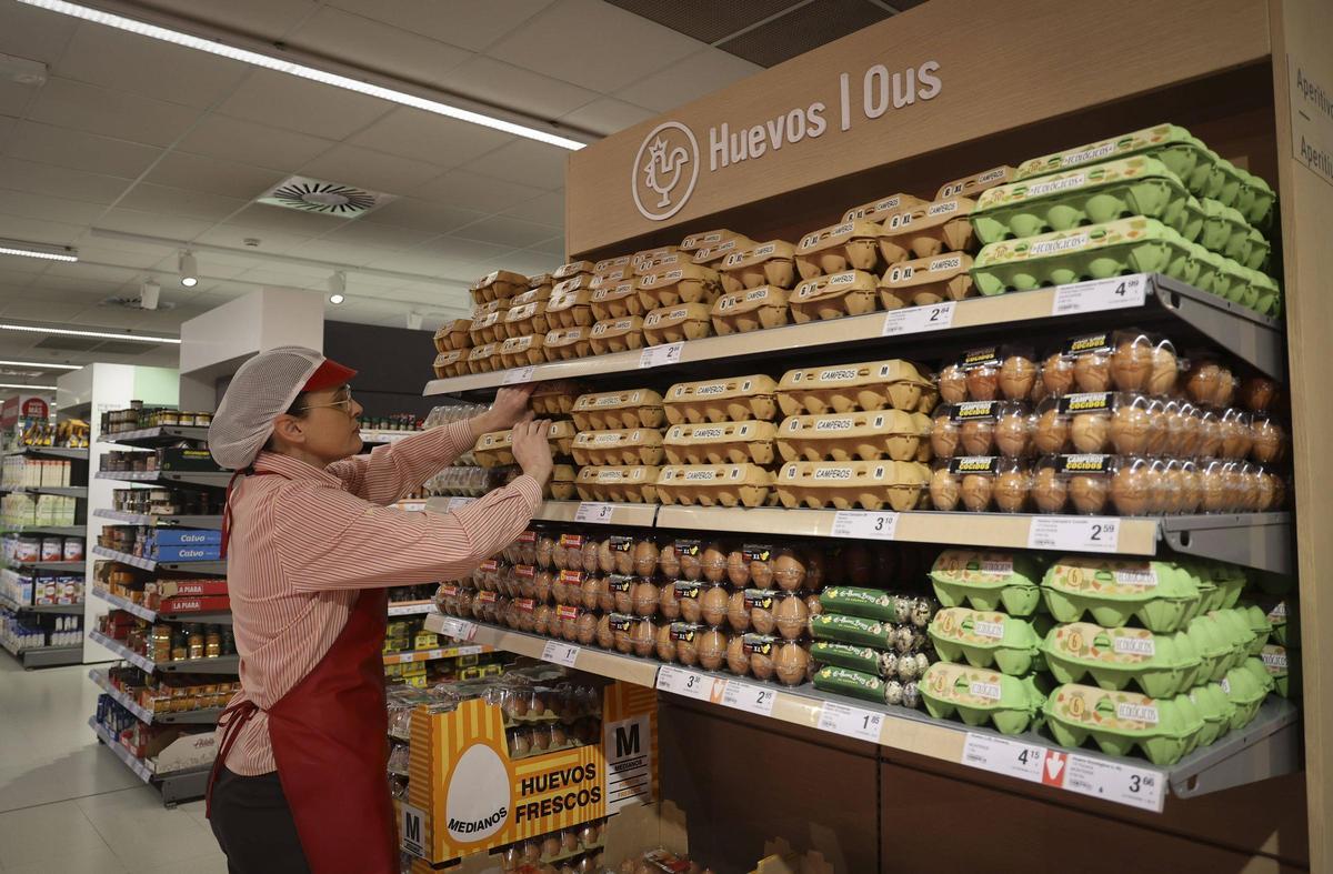 Una empleada de Consum en la zona de huevos de un supermercado