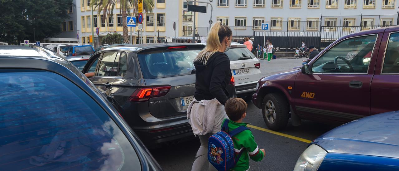 Una mujer con un niño van al colegio en la zona de Arenales.