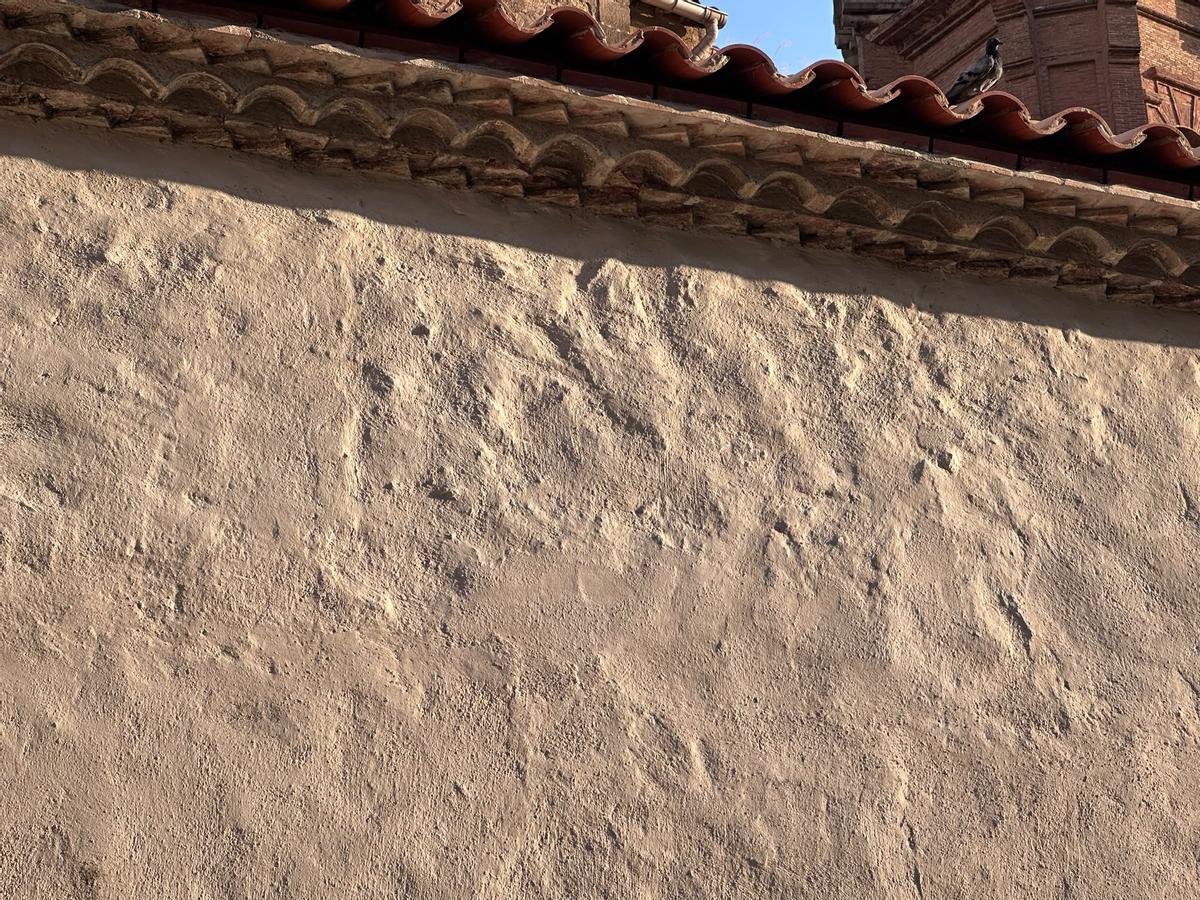 La luz del atardecer resalta la nueva textura de la pared de la Capella dels Segadors tras la criticada rehabilitación
