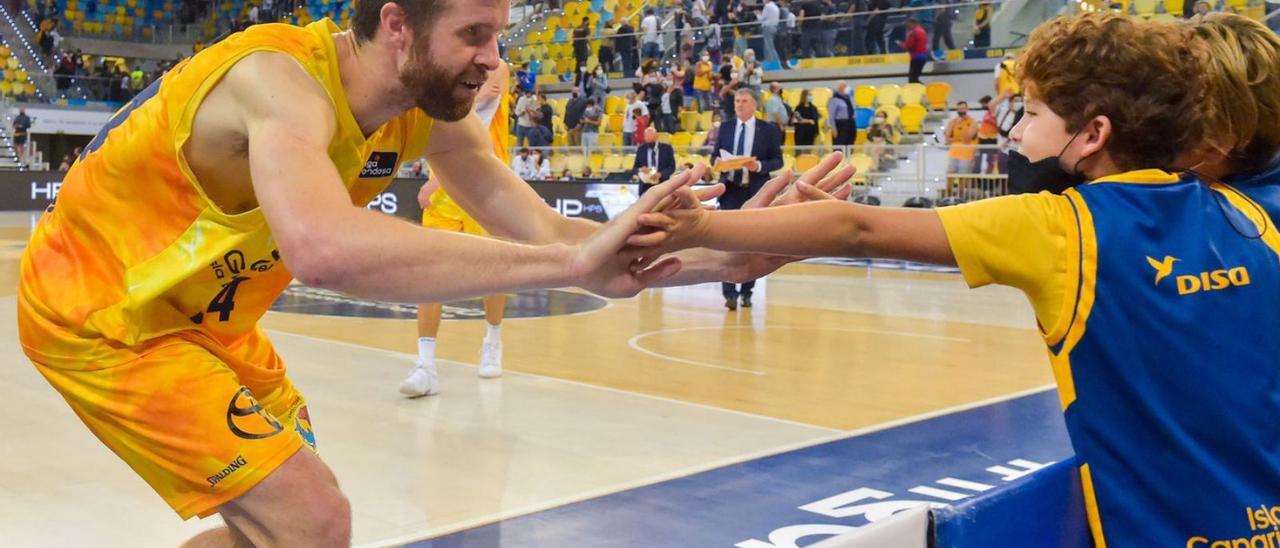 John Shurna, ex del Valencia Basket, saluda a un joven aficionado amarillo tras el partido ante el Zaragoza. | | ANDRÉS CRUZ