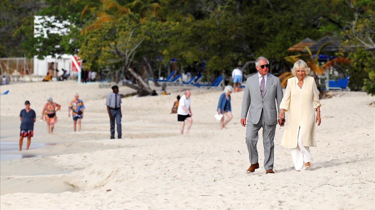 El principe Carlos de Inglaterra pasea, junto a la duquesa Camila, por la playa de Grand Anse durante su visita a la isla de Granada.