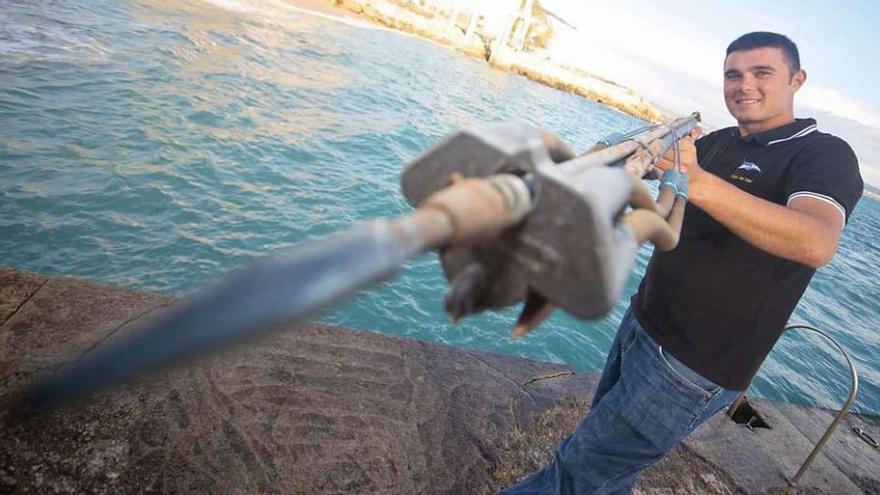 El campeón del mundo Andrés Pita posa con un utensilio de pesca en las instalaciones del Club del Mar. 13fotos