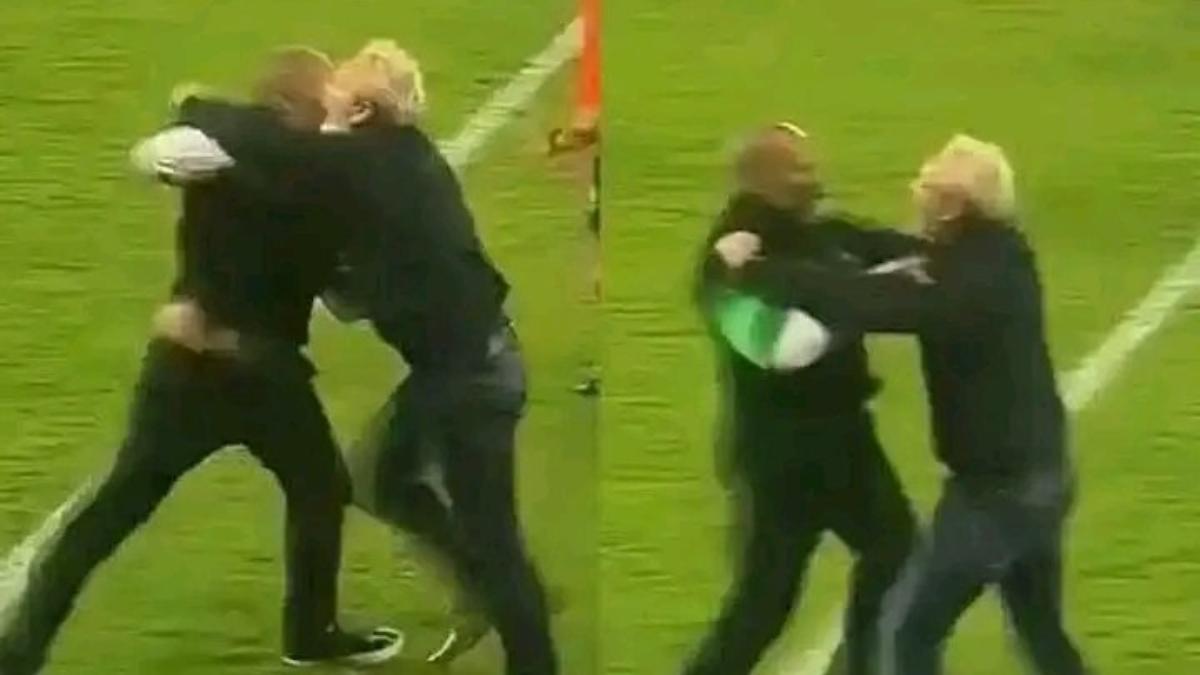 Éric Chelle, seleccionador de Nigeria, siendo frenado por un miembro de su cuerpo técnico