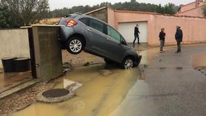 fcasals45470824 residents stand by a car swept away by floods on october 15 181015093031