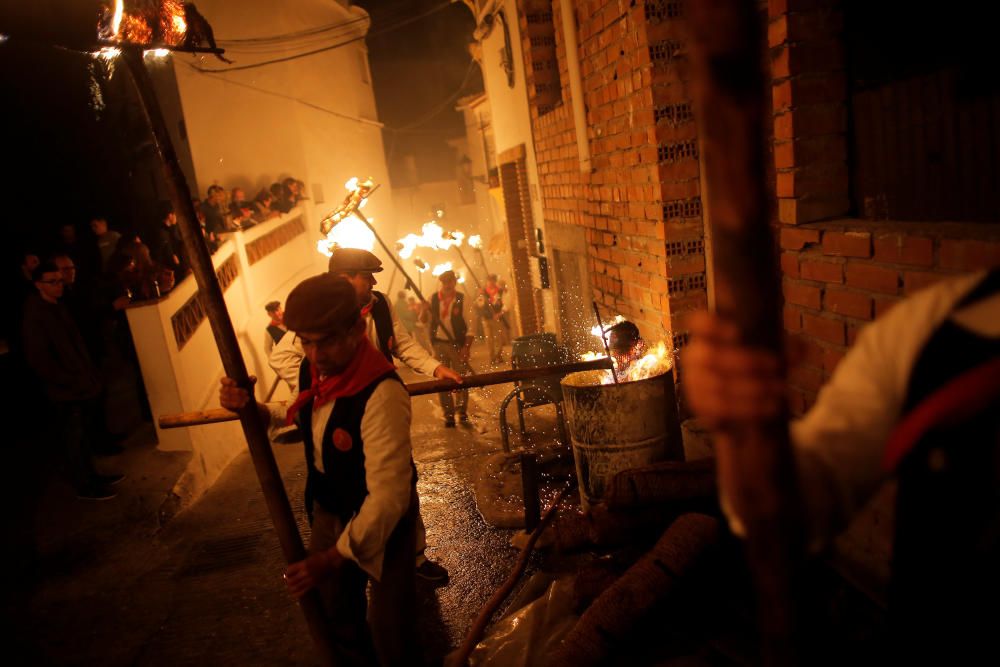 Villagers hold torches during the Divina Pastora ...