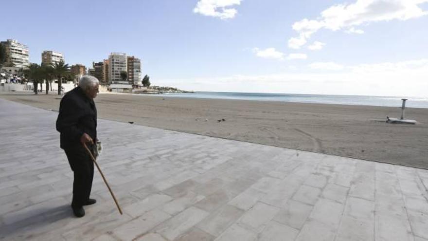 Un hombre mayor pasea solo por la playa en Alicante, en una imagen de archivo.