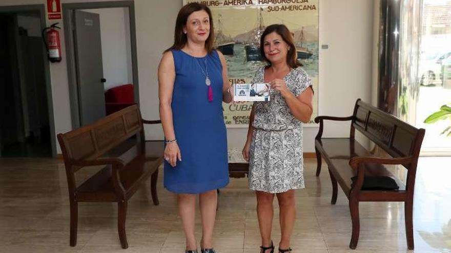 María Victoria Iglesias (i.) entrega el cheque a Beatriz Fonseca. // FDV