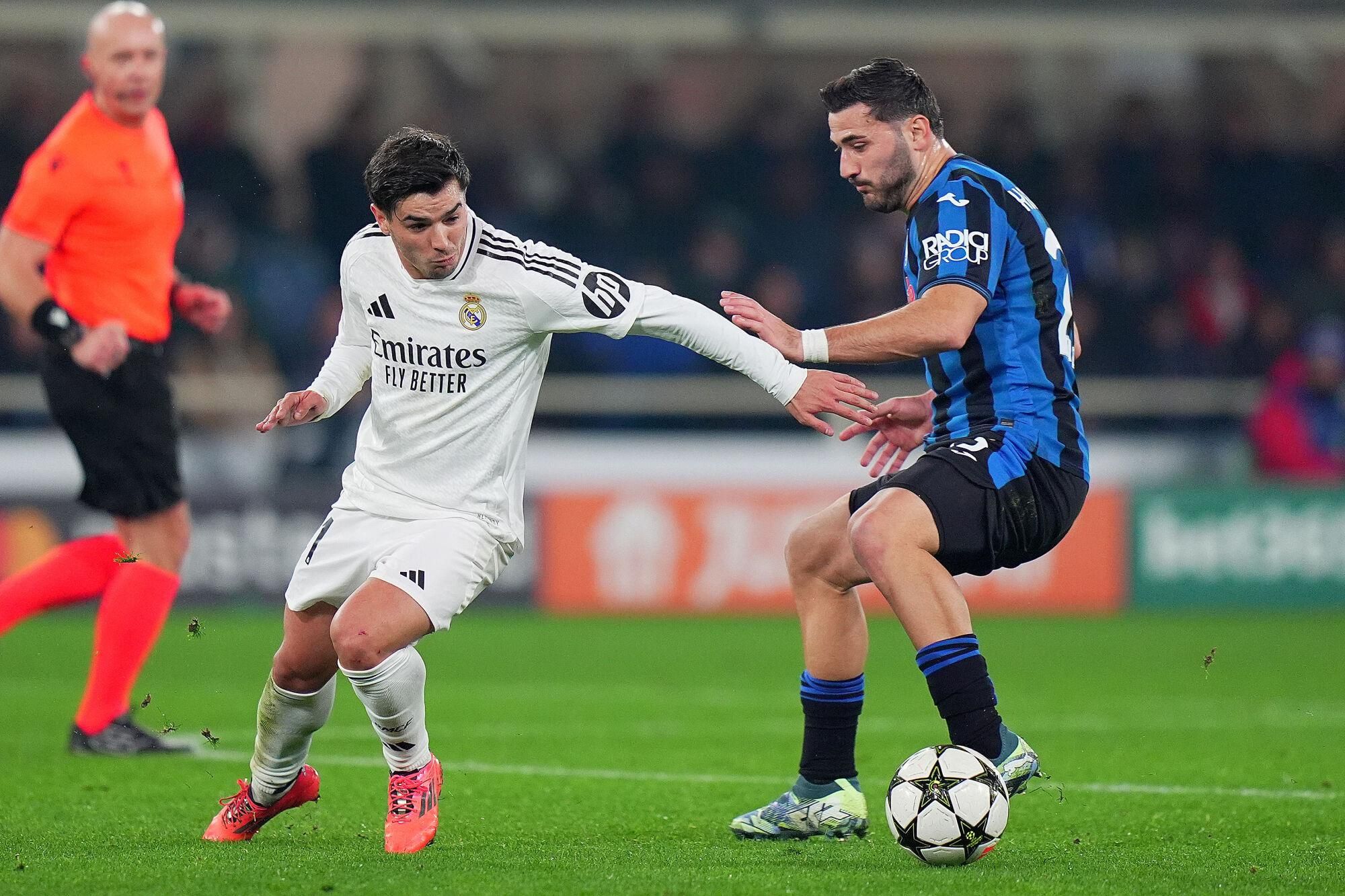 Real Madrid's Brahim Diaz  fight for the ball with Atalanta's Sead Kolasinac  during the Uefa Champions League soccer match between Atalanta and Real Madrid  a at the Gewiss Stadium in Bergamo, north Italy - Tuesday , December  10  , 2024. Sport - Soccer . (Photo by Spada/LaPresse)