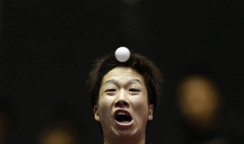 Japan's Mizutani eyes the ball as he hits a return to Romania's Cazacu during the World Team Table Tennis Championships in Tokyo