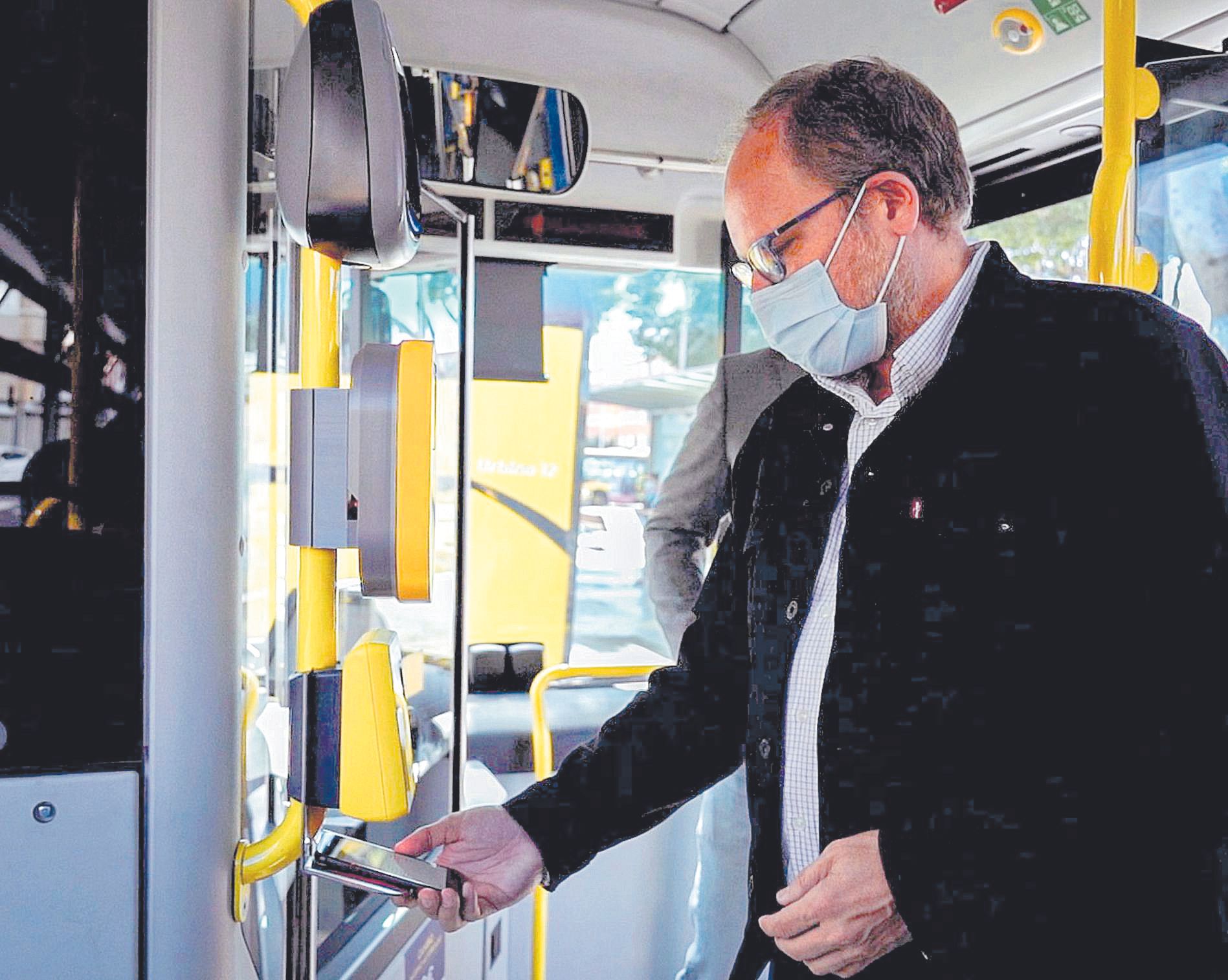 El concejal José Eduardo Ramírez hace una demostración de pago a través del  móvil en una guagua de la línea 12.