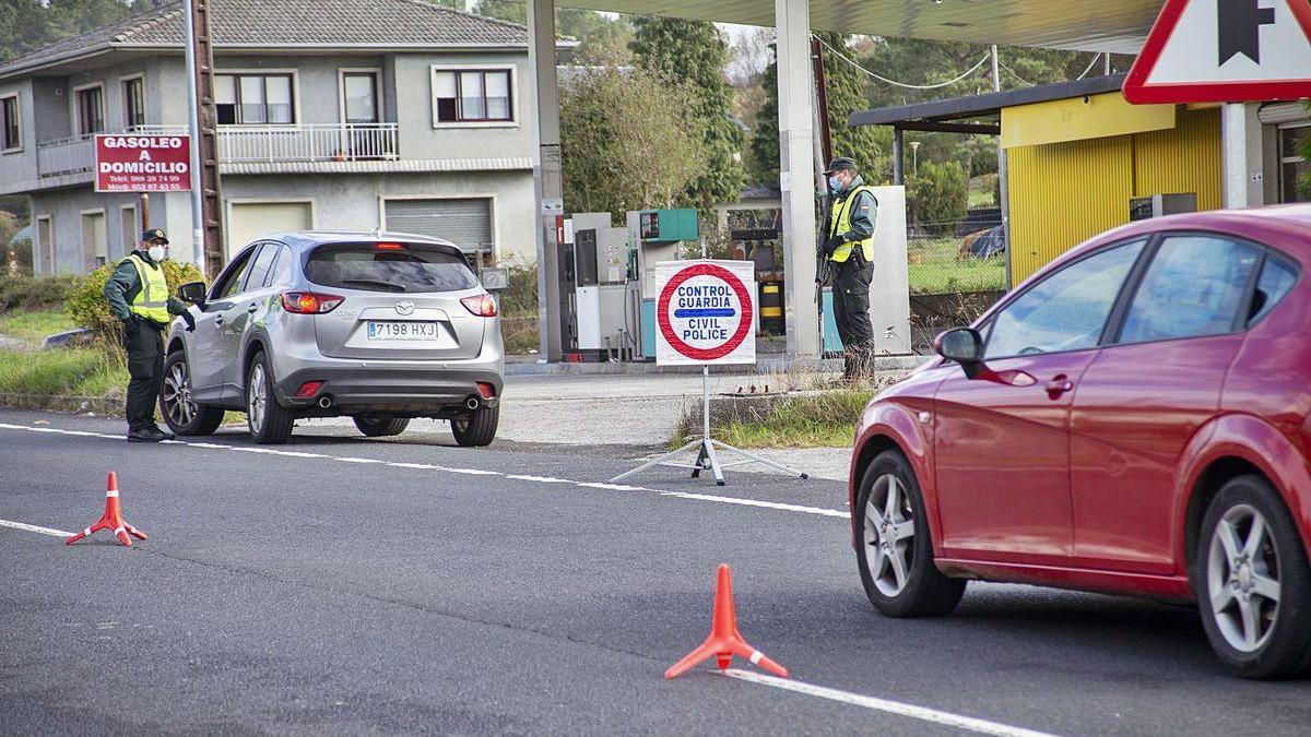 Dos agentes de la Guardia Civil identifican al conductor de un turismo y los motivos de su desplazamiento en O Irixo.