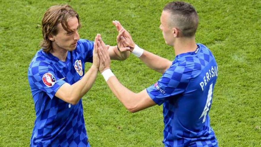 Modric saluda a Perisic en el momento de ser sustituido. // Efe