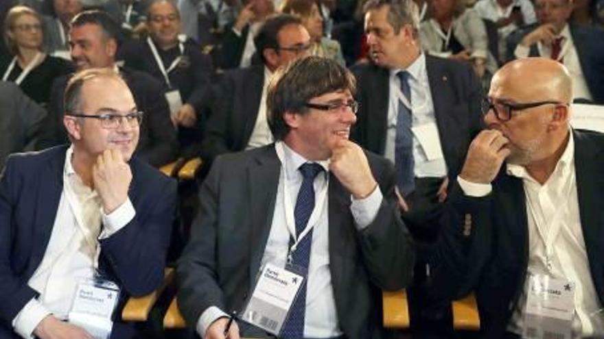 Carles Puigdemont, entre Jordi Turull i Lluís Corominas, ahir al consell nacional extraordinari del PDeCAt