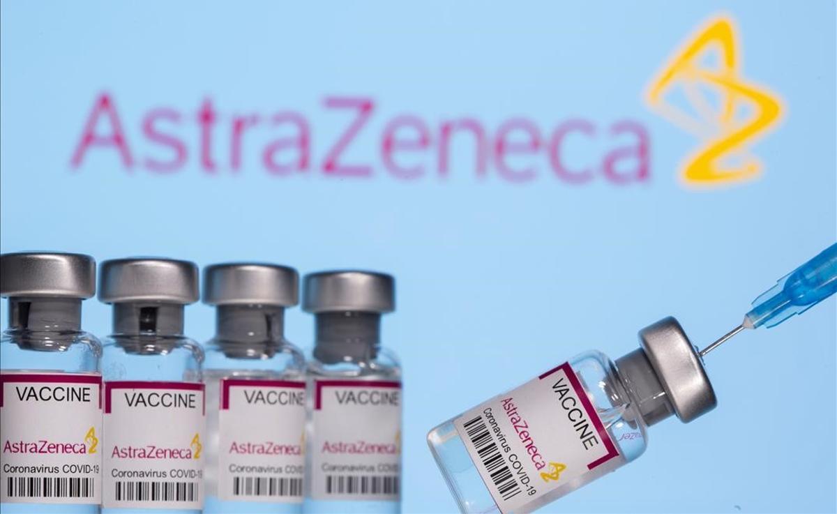 Vials labelled  Astra Zeneca COVID-19 Coronavirus Vaccine  and a syringe are seen in front of a displayed AstraZeneca logo  in this illustration photo taken March 14  2021  REUTERS Dado Ruvic Illustration