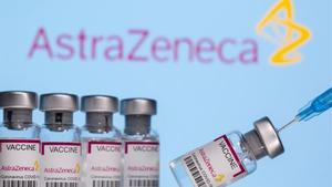 Vials labelled  Astra Zeneca COVID-19 Coronavirus Vaccine  and a syringe are seen in front of a displayed AstraZeneca logo  in this illustration photo taken March 14  2021  REUTERS Dado Ruvic Illustration