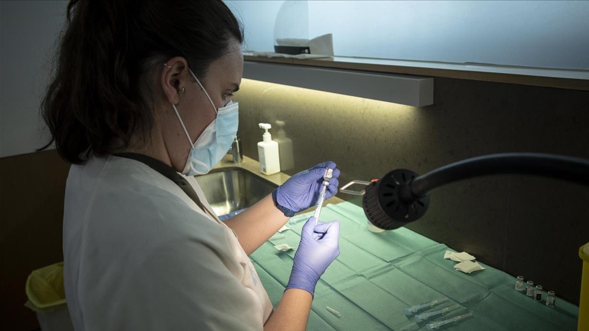Una enfermeras del CAP de Poblenou de Barcelona prepara una vacuna de Pfizeren el Casal de Gent Gran Quatre Cantons, el pasado 23 de marzo