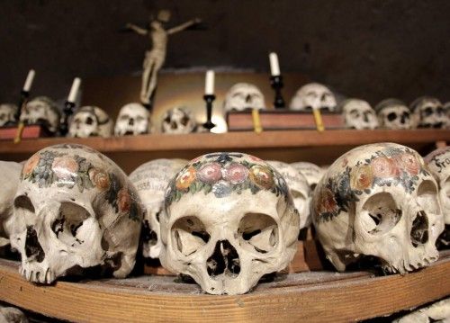 Human skulls and bones are displayed at the Bone House in Hallstatt
