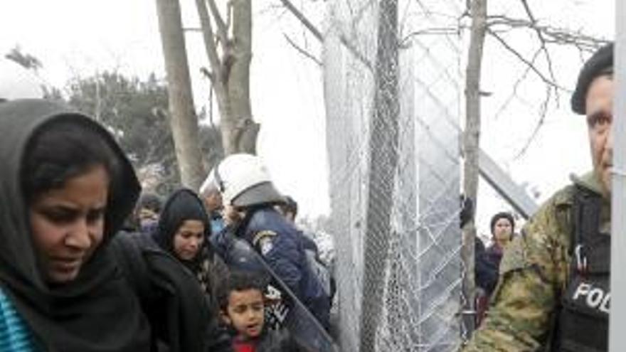 Refugiados cruzan entre Grecia y Macedonia.
