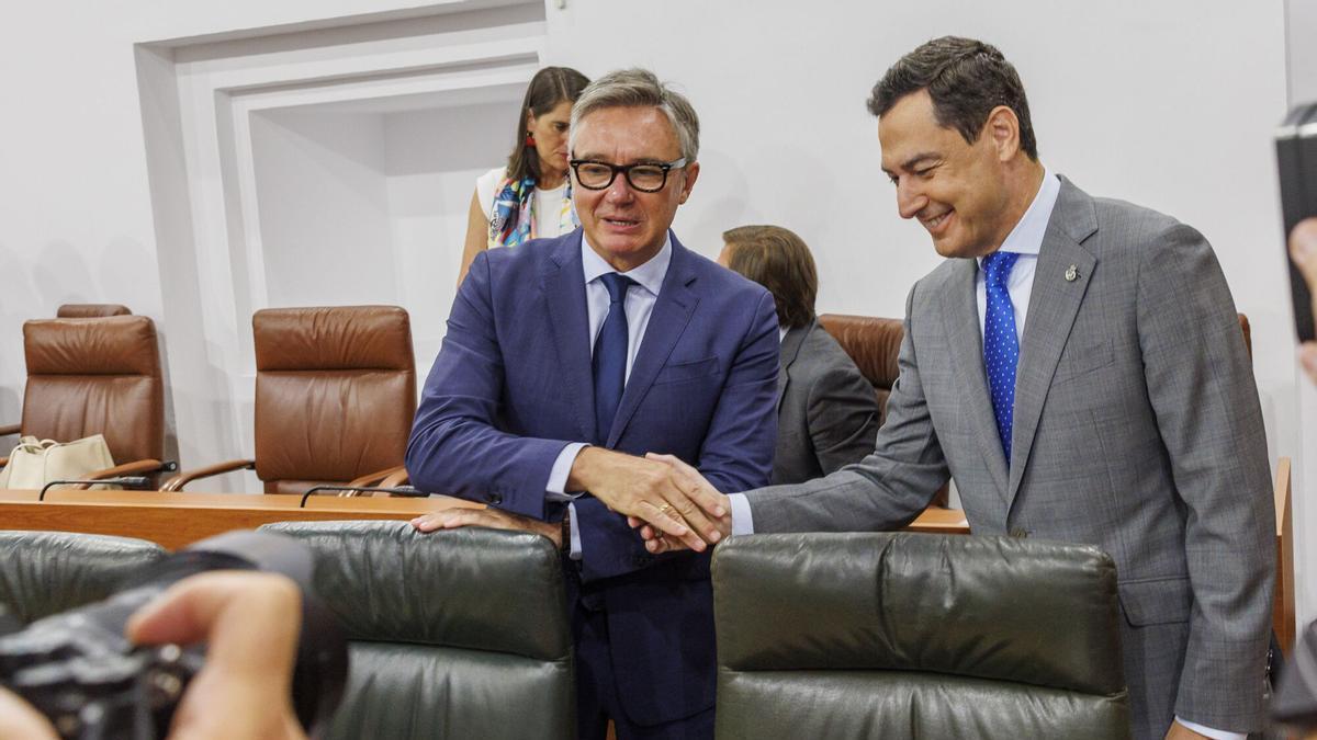 El presidente andaluz, Juanma Moreno, y el vicepresidente Manuel Gavira, de Vox, se saludan al inicio del pleno del Parlamento andaluz.