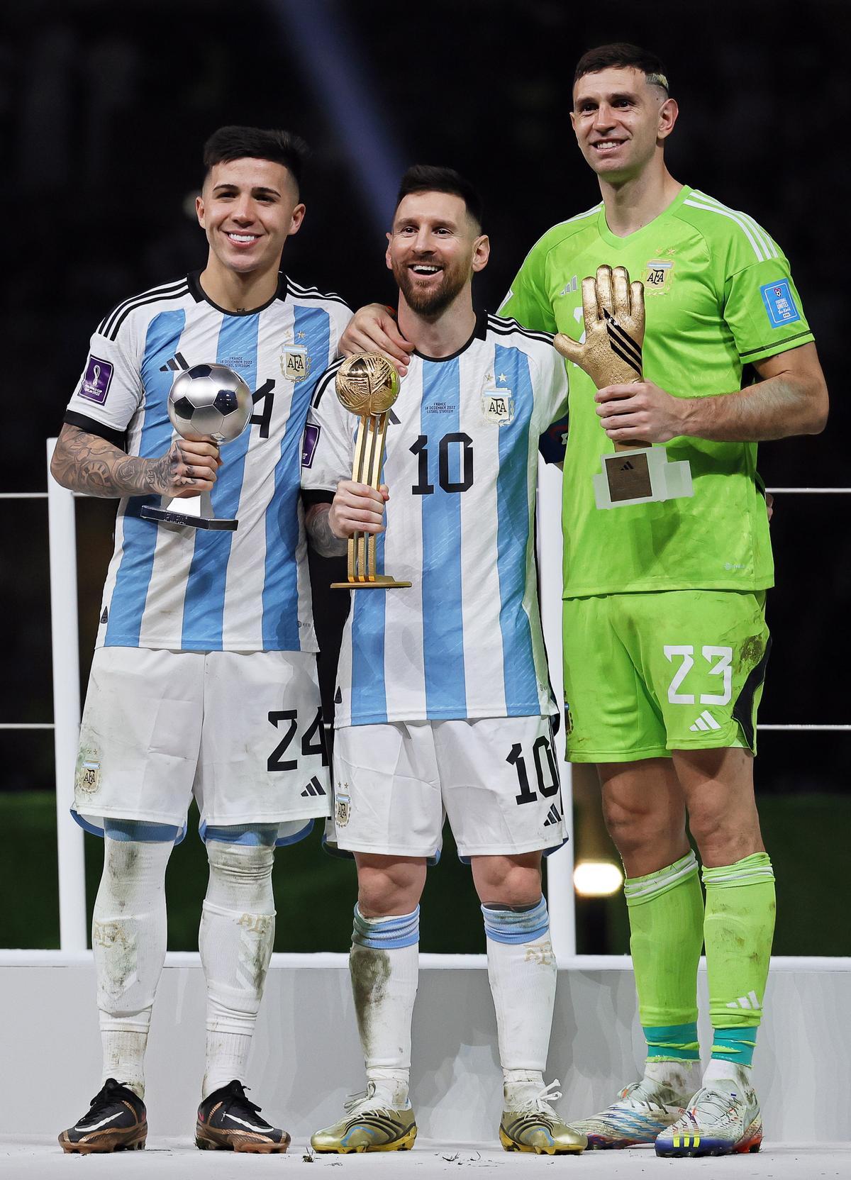 Lusail (Qatar), 18/12/2022.- Argentinian players (L-R) Enzo Fernandez, Lionel Messi, and goalkeeper Emiliano Martinez, pose with their award trophies after the FIFA World Cup 2022 Final between Argentina and France at Lusail stadium in Lusail, Qatar, 18 December 2022. Argentina won 4-2 on penalties. (Mundial de Fútbol, Francia, Estados Unidos, Catar) EFE/EPA/Ronald Wittek