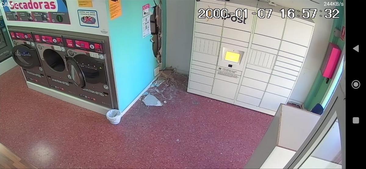 Daños en una lavandería de València tras el asalto de dos ladrones que arrancaron la máquina de cambio.