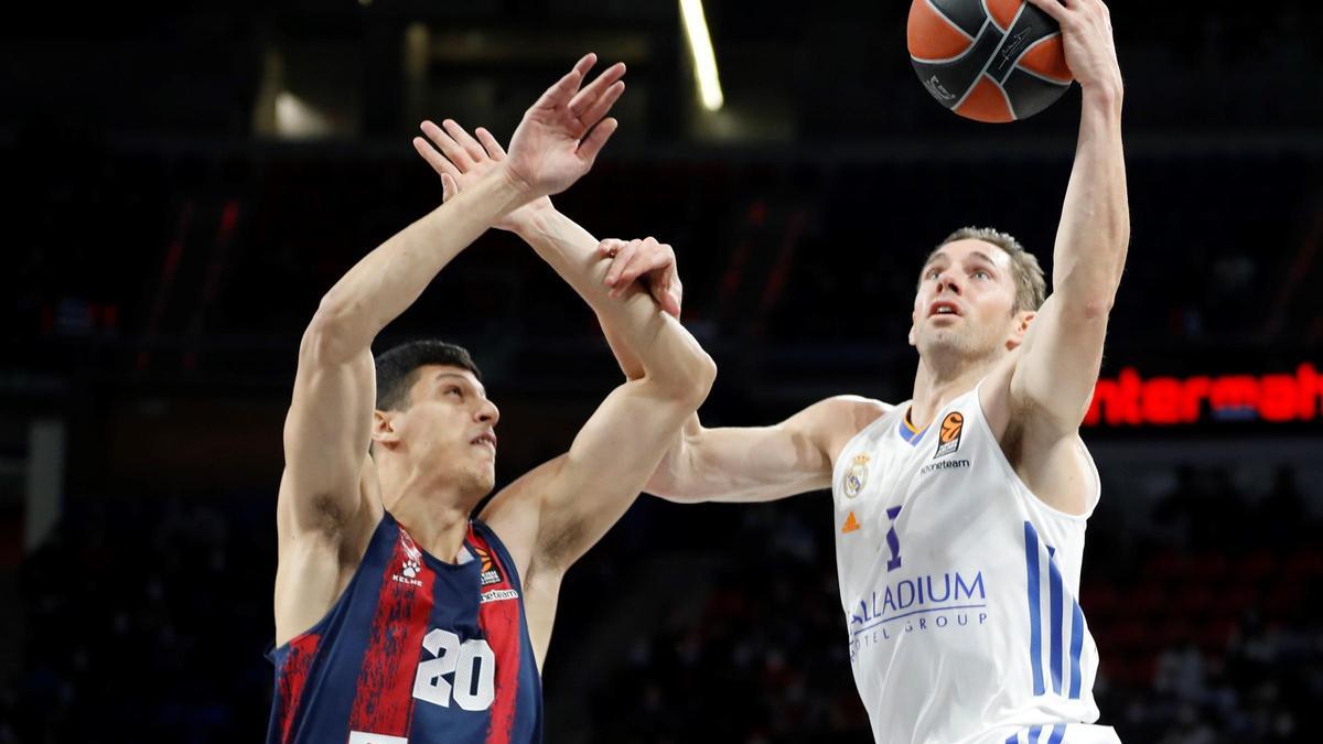 El ala-pívot italiano del Baskonia Simone Fontecchio (i) lucha con el alero francés del Real Madrid Fabian Causseur.