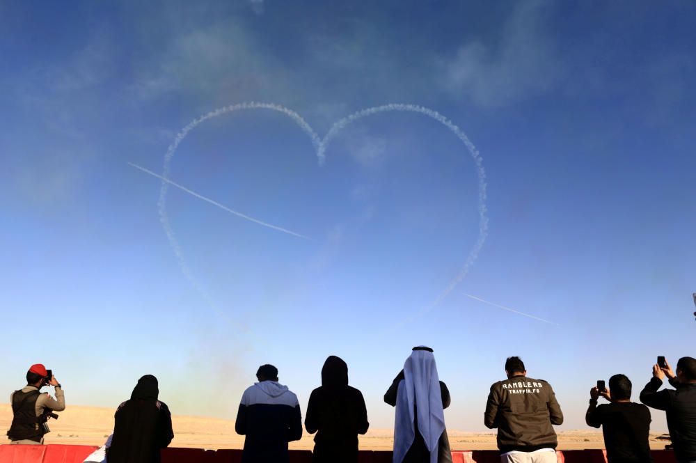 People watch as aircrafts perform during an ...