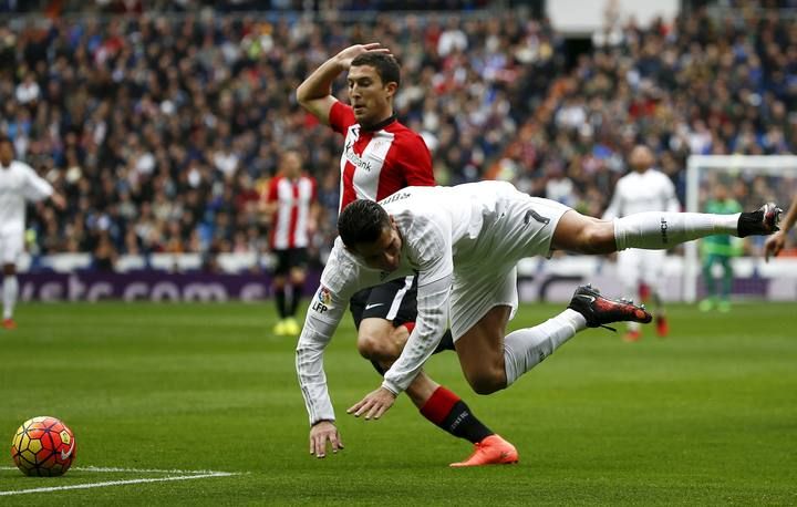 Real Madrid's Cristiano Ronaldo falls to the ground