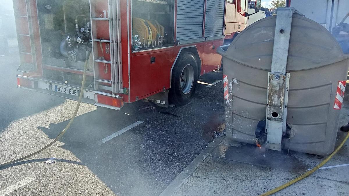 Los bomberos sofocando el fuego en un contenedor de la calle San Cristóbal.